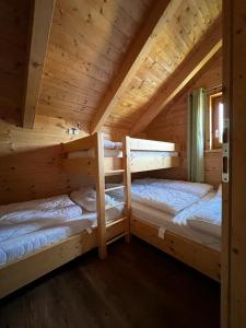 a log cabin with two bunk beds in it at Höhenchalet Klippitz in Bad Sankt Leonhard im Lavanttal