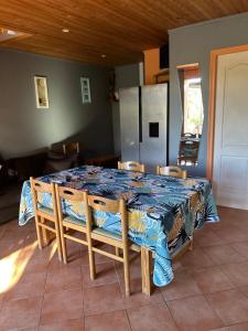 a dining room table with a blue and white table cloth at Maison 9 couchages avec piscine et jardin au calme in Barbaggio +10 photos