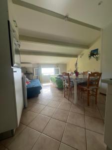 a kitchen and dining room with a table and chairs at vue mer Studio 2/3 pers 1 bed + 1 cot in Farinole