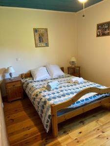 a bedroom with a bed and a wooden floor at Maison 9 couchages avec piscine et jardin au calme in Barbaggio