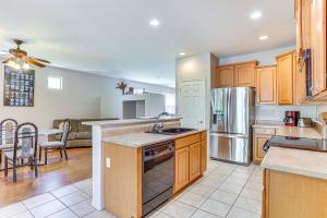a kitchen with a sink and a refrigerator at Goodyear Getaway with Private Pool and Outdoor Lounge! in Goodyear