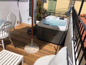 a hot tub on the balcony of a house at Evagelia's Villas in Skopelos Town