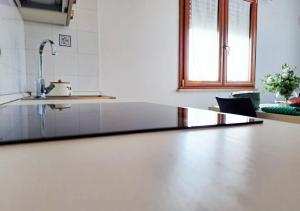 a kitchen with a counter top and a sink at Aida Guest House - Decimomannu in Decimomannu