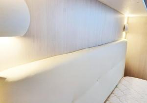 a corner of a room with a bed and a light at Aida Guest House - Decimomannu in Decimomannu