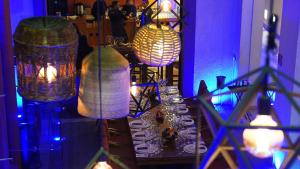 a table with plates and glasses on it with lights at HOTEL BOUTIQUE CASA DEL BOSQUE in Tlaxcala de Xicohténcatl