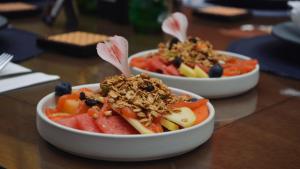 two bowls of food with fruit and nuts on a table at HOTEL BOUTIQUE CASA DEL BOSQUE in Tlaxcala de Xicohténcatl
