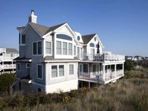 a large house sitting on top of a beach at Beach Front Luxury Vacation Rental On Lbi in Surf City
