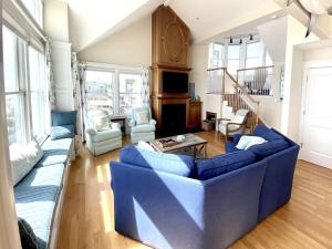 a living room with a blue couch and chairs at Beach Front Luxury Vacation Rental On Lbi in Surf City