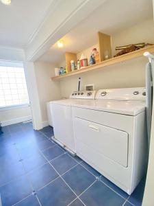 a kitchen with a washer and dryer on a blue tile floor at Beach Front Luxury Vacation Rental On Lbi in Surf City