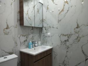 a bathroom with a sink and a mirror at Nefeli -1BR Lux Apartment - Tsimiski Ladadika - Explore Center by foot - Close to Aristotelous square in Thessaloniki