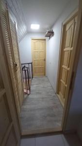 a hallway with a door and some chairs and a table at Happy Guests Residence in Sibiu