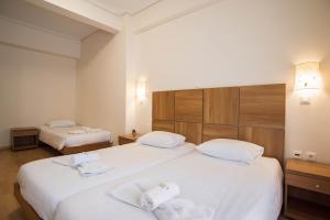 Letto o letti in una camera di THOLOS HOTEL