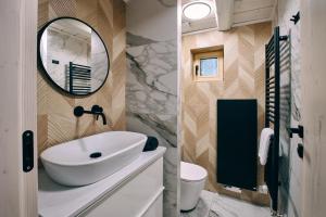 a bathroom with a sink and a mirror at Jizerína in Bedřichov