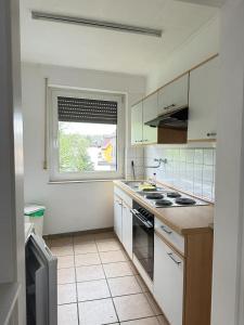 a kitchen with a stove and a window in it at Holiday Apartment Adenau in Adenau
