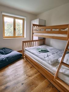 two bunk beds in a room with wooden floors at Jizerína in Bedřichov