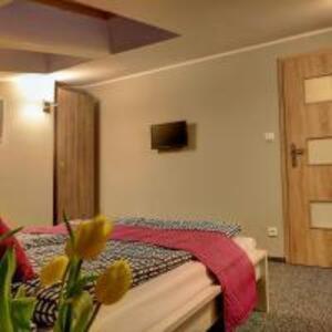 1 dormitorio con 1 cama y TV en la pared en VACATION CLUB LEBA en Łeba