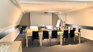 a conference room with a table and chairs at Horský hotel Brans in Malá Morávka