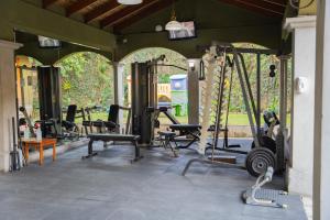 a gym with a bunch of treadms and weights at Casa Conde Hotel & Apartamentos in San José