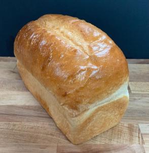 a loaf of bread sitting on a cutting board at Claymore Inn and Suites in Antigonish