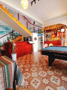 a living room with a pool table and stairs at NiNi Homestay Sapa in Sa Pa