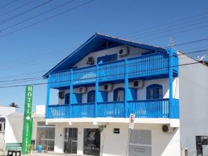 a blue and white building with a blue balcony at Hotel Costa Praia in Piçarras