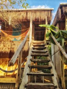 a staircase leading up to a house with a thatched roof at Pousada Roy Bonete in Ilhabela