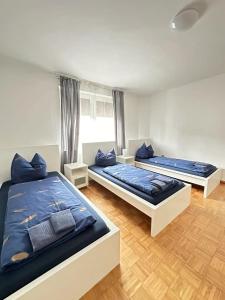 two beds in a room with blue pillows at Holiday Apartment Adenau in Adenau