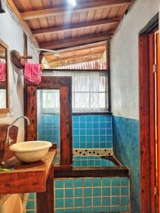 a bathroom with a sink and blue tiles at Pousada Roy Bonete in Ilhabela