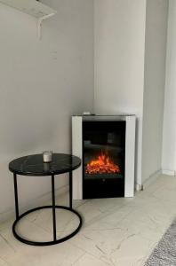 a fireplace with a table in front of it at Leben am Dortmunder U in Dortmund