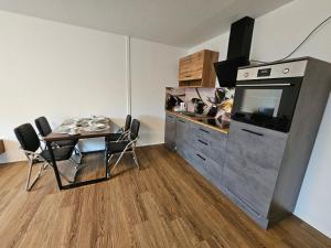 a small dining room with a table and a television at Ferienwohnung Medina in Bad Wildungen +11 photos