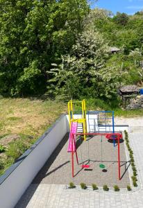 a play area with two colorful chairs in a sandbox at Vila Simfonija with Free parking in Vrnjačka Banja