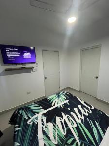 a room with a flat screen tv on a wall at Residencial Sosua 1-2 in Sosúa