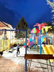 a group of children playing on a playground at Muras Ordo Hotel in Bishkek