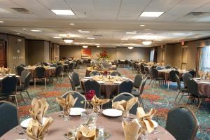 a banquet hall with tables and chairs in a room at Holiday Inn Hotel & Suites Council Bluffs, an IHG Hotel in Council Bluffs
