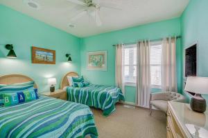 a bedroom with two beds and a window at Grand Seaside Escape with Direct Beach Access! in Corolla +37 photos