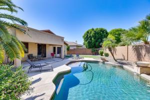 a swimming pool in the backyard of a house at Goodyear Getaway with Private Pool and Outdoor Lounge! in Goodyear