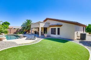 a house with a yard with a swimming pool at Goodyear Getaway with Private Pool and Outdoor Lounge! in Goodyear