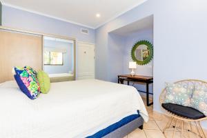 a bedroom with a white bed and a chair at Sunrise 2 - 3 Bedroom Condo At Tamarindo in Tamarindo +30 photos