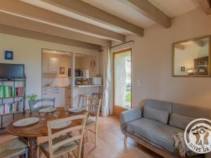 a living room with a table and a couch at Gîte rustique avec 2 chambres, nature, animaux admis, wifi et parking - FR-1-622-78 in Vihiers +27 photos