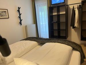 a bedroom with a bed and a tv and a window at Haus Anna in Sankt Anton am Arlberg