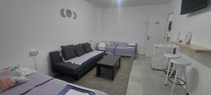 a living room with a couch and a bed at Coordenadas Ibiza in Ibiza Town