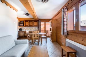 ein Wohnzimmer mit Sofa und Tisch in der Unterkunft Résidence Les Fermes du Soleil - maeva Home - Appartement 3 Pièces 6 Personnes - Sélection MAE-1535 in Les Carroz d'Araches