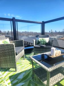 a patio with chairs and a table on a balcony at Cozy 3 story Townhouse! in Niagara Falls