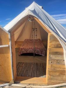 a tent with a bed inside of it at New Yurt City in Lake Los Angeles