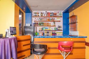 a bar with two chairs and a counter at Paleo Hotel and Spa in Thika