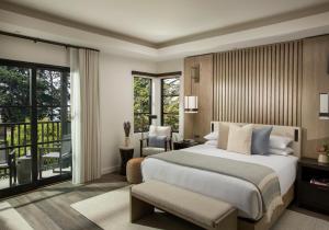 a bedroom with a large bed and a balcony at Stilwell Hotel in Carmel