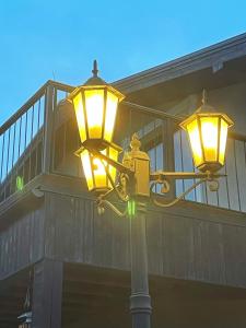 uma luz de rua com duas luzes num edifício em Brīvdienu māja Dinary em Dagda