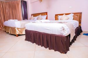 Postel nebo postele na pokoji v ubytování Paleo Hotel and Spa, Thika