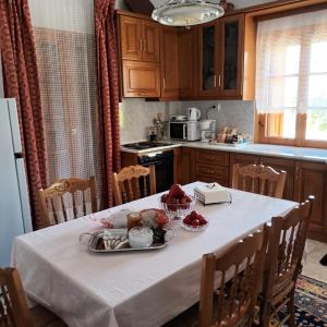 a kitchen with a table with a plate of food on it at Georgia House Portaria in Portariá +30 photos