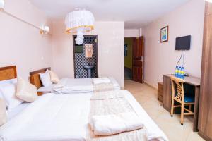 Postel nebo postele na pokoji v ubytování Paleo Hotel and Spa, Thika